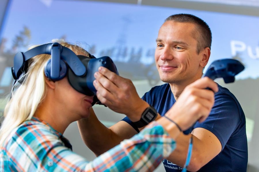 Ein Professor richtet die Datenbrille einer Probandin. 