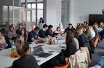 Foto: Studierende sitzen an einem Konferenztisch und führen ein Meeting.