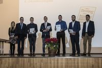 Gruppenfoto: Fünf Absolventen präsentieren mit dem Gratulanten ihre Urkunden.