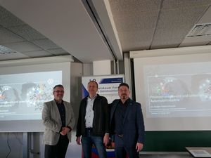 Foto: drei Personen blicken in die Kamera