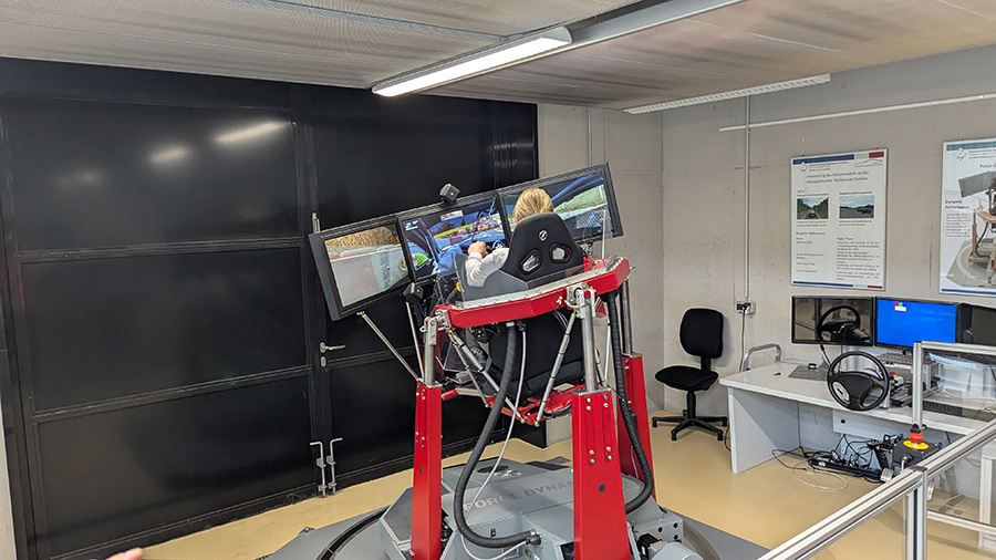 Ein Probant sitzt im dynamischen Fahrsimulator und fährt eine Simulation.