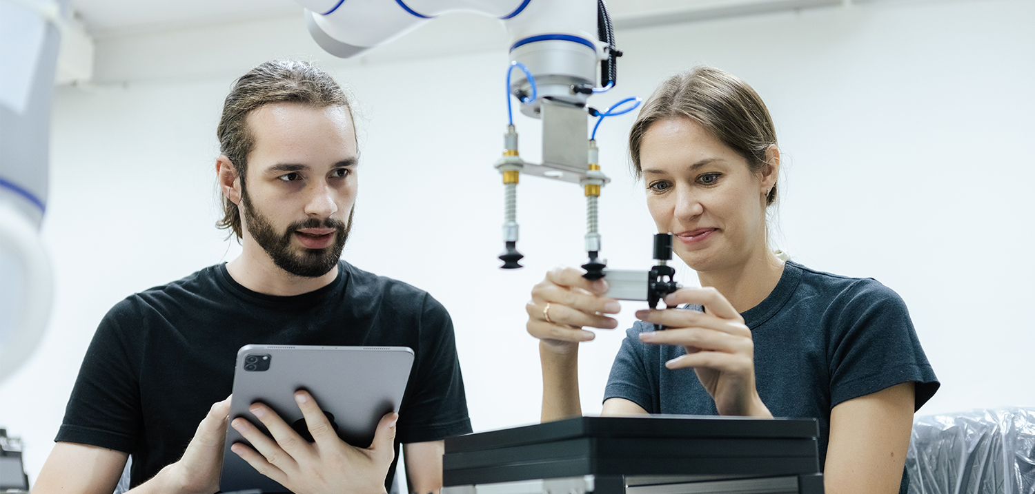 Male and female using tablet staff engineer with robot for education at class room. Education for future robotics learning innovation. Workshop maintenance 